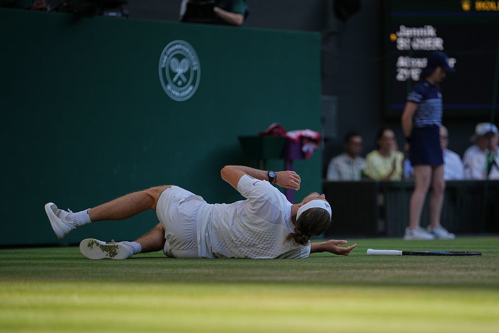 Alexander Zverev of Germany falls as he plays against Jannik Sinner of Italy during the mens singles final at Wimbledon Tennis Championships in London
