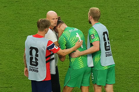 Norway head coach Stale Solbakken, left rear, and teammates console goalkeeper Oerjan Nyland (1) after the World Cup quarterfinal soccer match between Norway and England in Miami Gardens, Fla., Saturday, July 11, 2026.