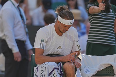 Alexander Zverev of Germany injects himself with insulin during a changeover in the men's singles final match against Jannik Sinner of Italy, at Wimbledon Tennis Championships in London