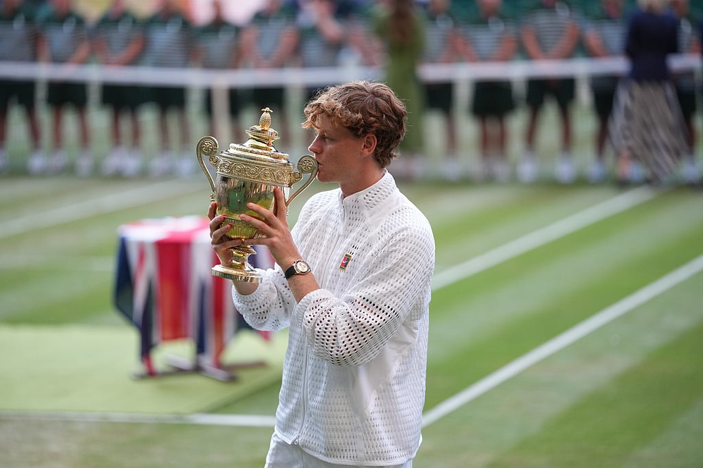 Jannik Sinner of Italy kisses his trophy after winning against Alexander Zverev of Germany in the mens singles final at Wimbledon Tennis Championships in London