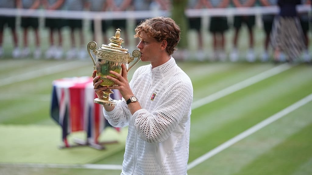 Jannik Sinner of Italy kisses his trophy after winning against Alexander Zverev of Germany in the men's singles final at Wimbledon Tennis Championships in London - Kirsty Wigglesworth/AP Photo