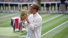 Jannik Sinner of Italy kisses his trophy after winning against Alexander Zverev of Germany in the men's singles final at Wimbledon Tennis Championships in London - Kirsty Wigglesworth/AP Photo