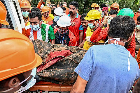 People carry the mortal remains of Vikram Rana (58), a construction manager from Himachal Pradesh, recovered during a search operation following the landslide on Tuesday at the tunnel project site in Kalladi, Wayanad, Kerala.