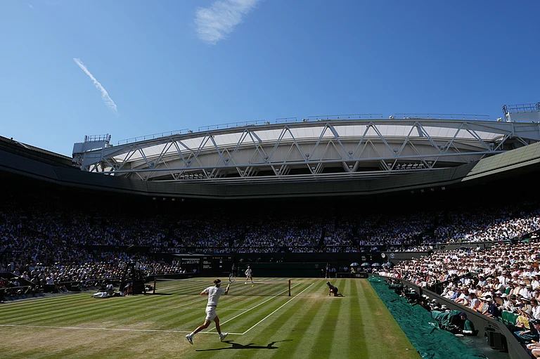 Alexander Zverev of Germany returns the ball to Jannik Sinner of Italy in the men's singles final at Wimbledon Tennis Championships in London - Kirsty Wigglesworth/AP Photo