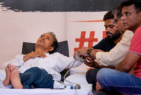 Climate activist Sonam Wangchuk being attended by a medical professional as Cockroach Janata Party (CJP) founder Abhijeet Dipke looks on during a hunger strike by CJP demanding action over alleged irregularities in examinations and seeking the resignation of Union Education Minister Dharmendra Pradhan, at Jantar Mantar, in New Delhi. Wangchuk is on the 16th day of his indefinite hunger strike. 