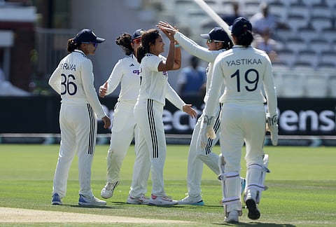 India's Sayali Satghare, center, celebrates with her teammates after taking the wicket of England's Maia Bouchier during day three of the first Women's Test match at Lord's cricket ground in London, Sunday July 12, 2026. 