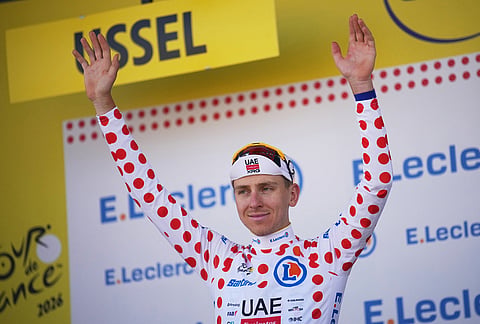 Slovenia's Tadej Pogacar, wearing the best climber's dotted jersey, celebrates on the podium after the ninth stage of the Tour de France cycling race with start in Malemort and finish in Ussel, France, Sunday, July 12, 2026. 