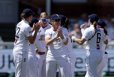England's Sophie Ecclestone, second left, celebrates with her teammates during day three of the first Women's Test match at Lord's cricket ground in London, Sunday July 12, 2026. 