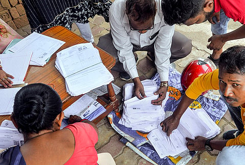 Booth Level Officers (BLOs) count the submitted enumeration forms as part of the ongoing Special Intensive Revision (SIR), in Ranchi.