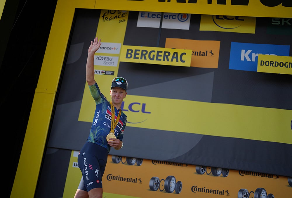 Belgium's Tim Merlier celebrates on the podium after winning the eighth stage of the Tour de France cycling race with start in Perigueux and finish in Bergerac, France, Saturday, July 11, 2026.  - | Photo: AP/Thibault Camus