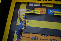 | Photo: AP/Thibault Camus : Belgium's Tim Merlier celebrates on the podium after winning the eighth stage of the Tour de France cycling race with start in Perigueux and finish in Bergerac, France, Saturday, July 11, 2026. 