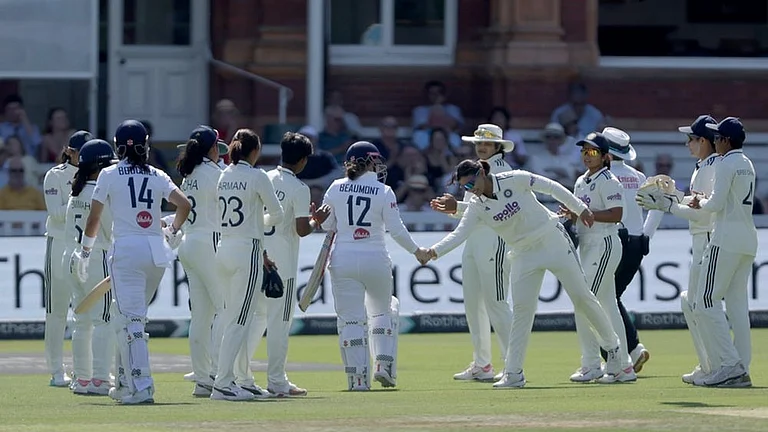 England's Tammy Beaumont, center, is given a guard of honour by India players following her final innings of international cricket after being bowled by Kranti Gaud during day three of the first Women's Test match at Lord's cricket ground in London. - | Photo: Steven Paston/PA via AP