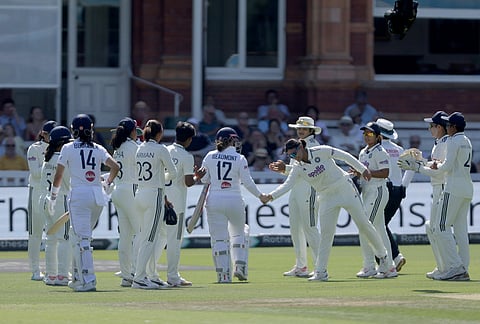 England's Tammy Beaumont, center, is given a guard of honour by India players following her final innings of international cricket after being bowled by Kranti Gaud during day three of the first Women's Test match at Lord's cricket ground in London, Sunday July 12, 2026. 