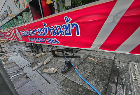 Shoes are seen scattered in front of a pub in Bangkok, Thailand after a fire. 