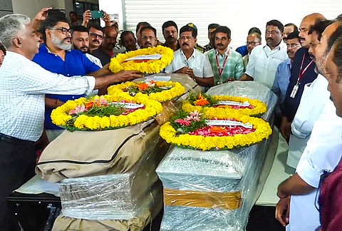 People pay their last respects to Vietnam speedboat capsize victims following their arrival at Thiruvananthapuram International Airport, in Thiruvananthapuram, Kerala.