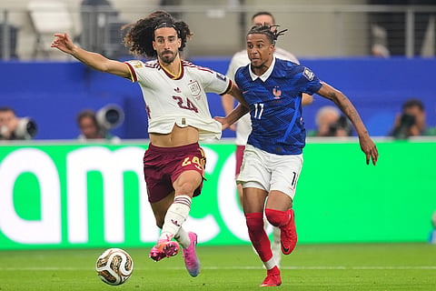 Spain's Marc Cucurella, left, ad France's Michael Olise vie for the ball during a World Cup semifinal soccer match