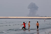 Iran War Hits Dubai Jobs, Indian Workers Face Layoffs And Pay Cuts | Photo: Razieh Poudat/ISNA via AP : Three boys play in the shallow waters of the Strait of Hormuz, Iran.