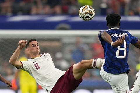 Spain's Fabian Ruiz (8) and France's Aurelien Tchouameni, right, vie for the ball during the World Cup semifinal soccer match