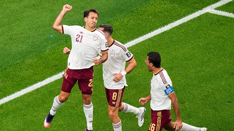 Spain's Mikel Oyarzabal (21) celebrates his goal on a penalty kick with Fabian Ruiz (8), and Rodri (16) during the World Cup - AP/David J. Phillip