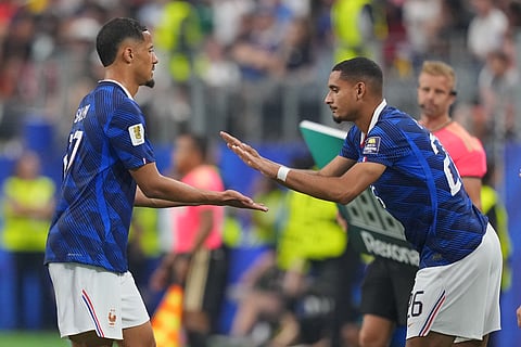 France's Maxence Lacroix, right, replaces William Saliba during a World Cup semifinal soccer match against Spain in Arlington