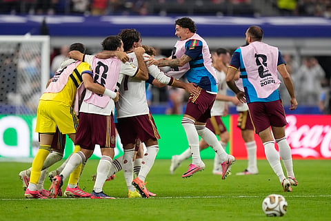 Spain players celebrate at the the end of the World Cup semifinal soccer match between France and Spain in Arlington, Texas