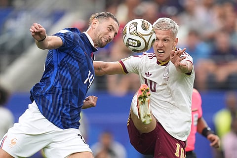 France's Adrien Rabiot (14) and Spain's Dani Olmo (10) go after the ball during the World Cup semifinal soccer match