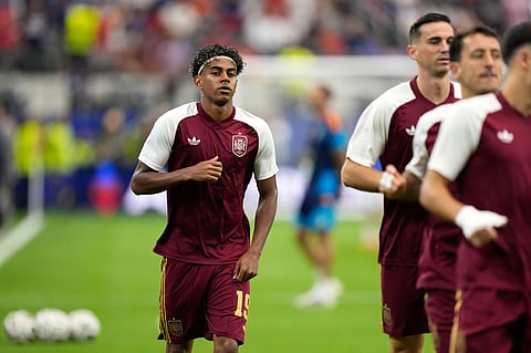 Spain's Lamine Yamal jogs during warmup before the World Cup semifinal soccer match between France and Spain in Arlington