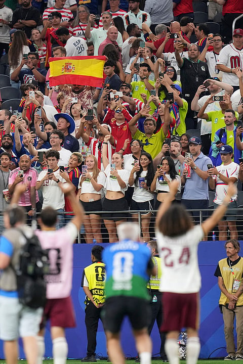 Members of Spain wave to fans after they defeated France the World Cup semifinal soccer match in Arlington, Texas