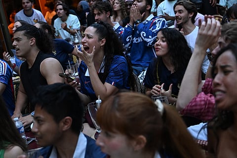 French fans react as they watch a broadcast of the World Cup semifinal soccer match between France and Spain, Tuesday, July 14, 2026, in Paris