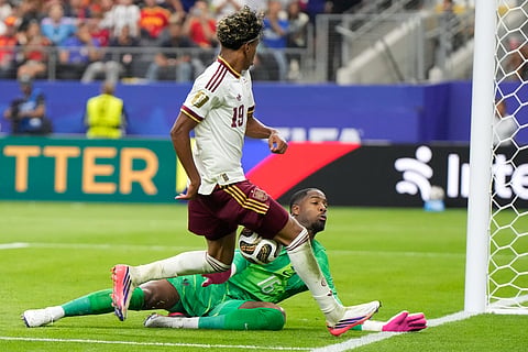 France goalkeeper Mike Maignan saves a shot from Spain's Lamine Yamal during the World Cup semifinal soccer match