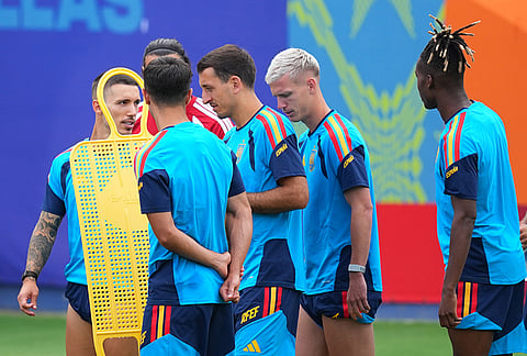Spain goalkeeper Joan Garcia, left, is visible through an obstacle during a training session ahead of his team's semifinal soccer match against France, Monday, July 13, 2026, in Dallas. 