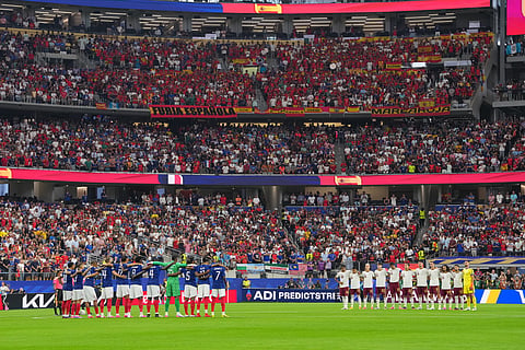 Players of France and Spain embrace ahead of their World Cup semifinal soccer match in Arlington, Texas, near Dallas