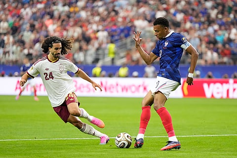 France's Kylian Mbappe passes the ball next to Spain's Marc Cucurella during the World Cup semifinal soccer match