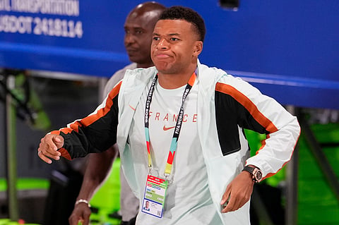 France's Kylian Mbappe (10) arrives at the stadium before the World Cup semifinal soccer match between France and Spain in Arlington