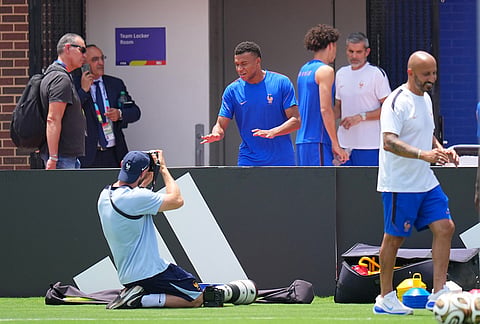 France's Kylian Mbappe, center, gestures toward a team photographer during a training session ahead of the team's semifinal soccer match against Spain, Monday, July 13, 2026, in Dallas. 