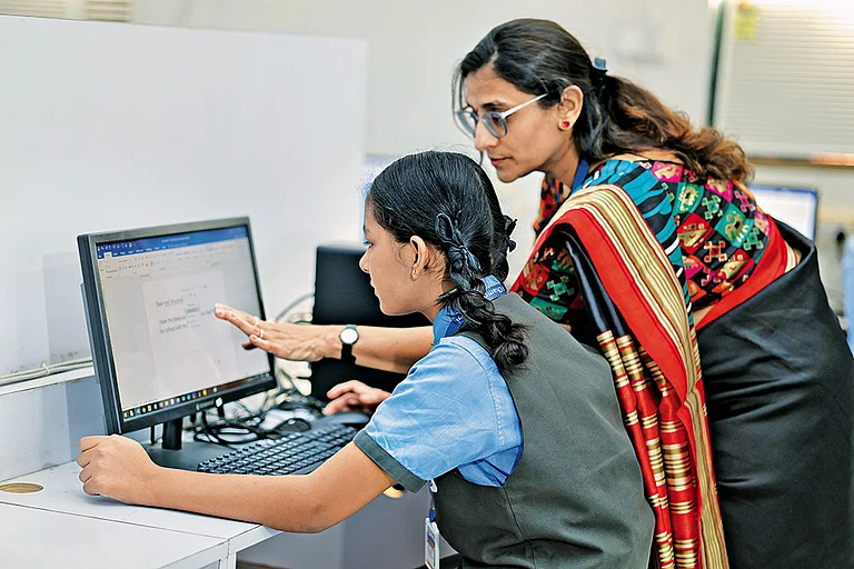Smooth Transition: A teacher explaining the basics of computer to a student - | Photo: Shutterstock