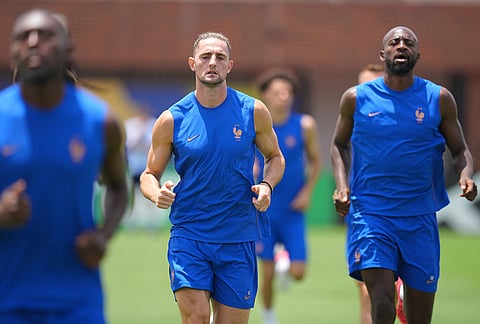 France's Adrien Rabiot, center, Manu Kone, left, and Jean-Philippe Mateta participate in a training session ahead of the team's semifinal soccer match against Spain, Monday, July 13, 2026, in Dallas. 