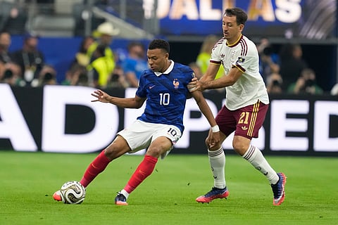 Spain's Mikel Oyarzabal (21) and France's Kylian Mbappe (10) challenge for the ball during the World Cup semifinal soccer match