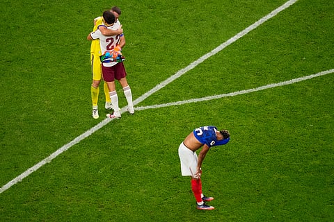 Spain goalkeeper Unai Simon (23) and Pau Cubarsi (22) celebrate as France's Desire Doue (20) pauses after the World Cup semifinal soccer match between France and Spain in Arlington