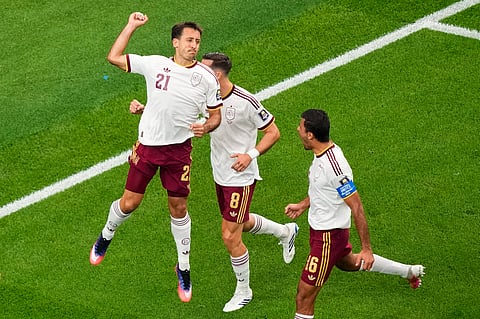 Spain's Mikel Oyarzabal (21) celebrates his goal on a penalty kick with Fabian Ruiz (8), and Rodri (16) during the World Cup