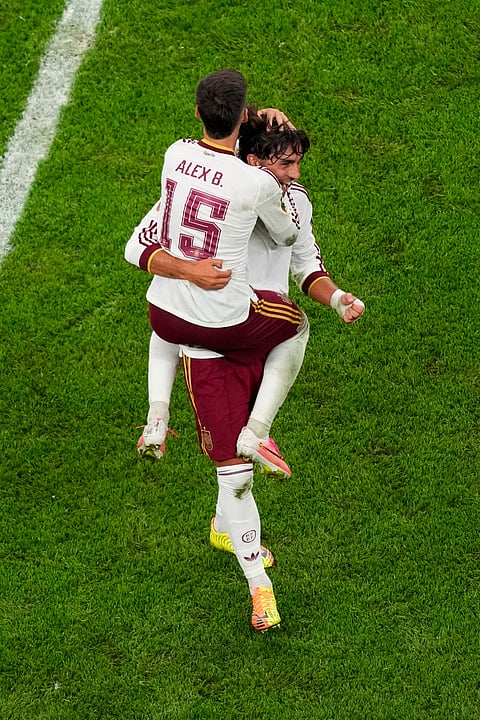 Spain's Alex Baena (15) celebrates with Ferran Torres after the World Cup semifinal soccer match between France and Spain in Arlington, Texas, near Dallas