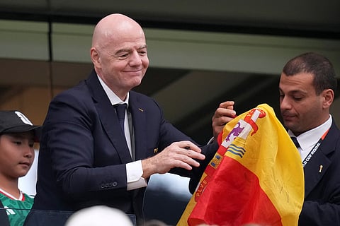 FIFA president Gianni Infantino signs autographs after Spain defeated France the World Cup semifinal soccer match