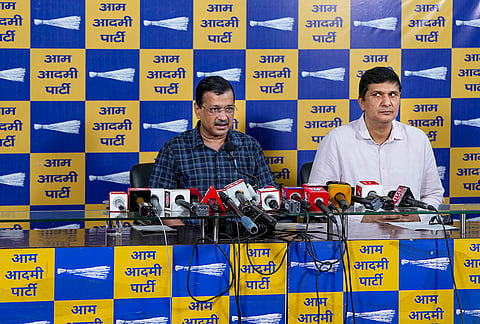 AAP National Convenor Arvind Kejriwal, left, addresses a press conference at party office, in New Delhi.