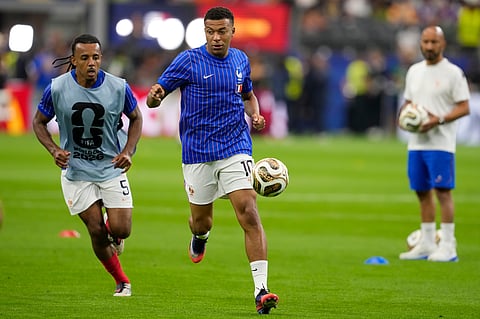 France's Kylian Mbappe and teammates work up prior to their a World Cup semifinal soccer match against France in Arlington