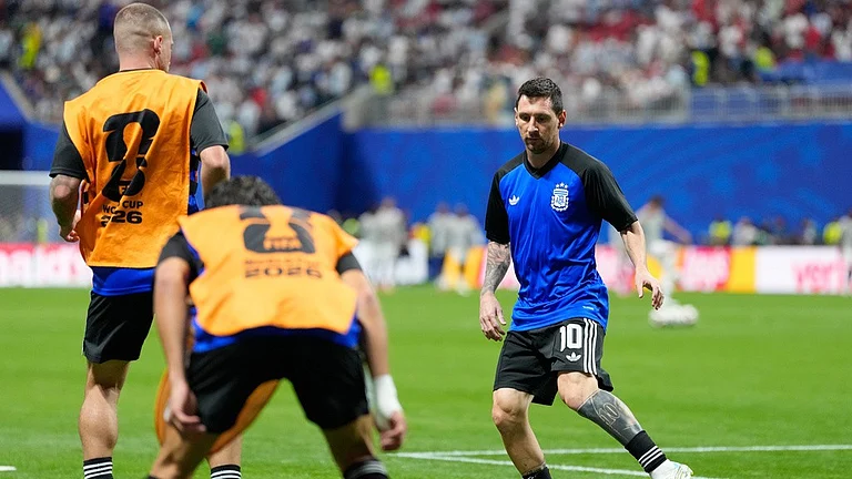 Argentina's Lionel Messi kicks a ball during warmup before the World Cup semifinal soccer match between England and Argentina in Atlanta - Rebecca Blackwell/AP Photo