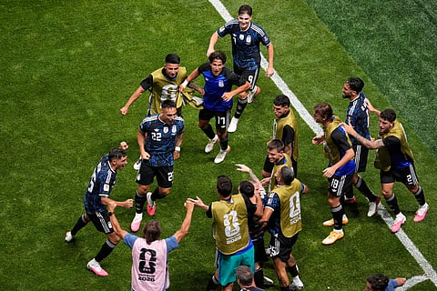 Argentina's Lautaro Martinez (22) celebrates with teammates after scoring their second goal during the World Cup semifinal