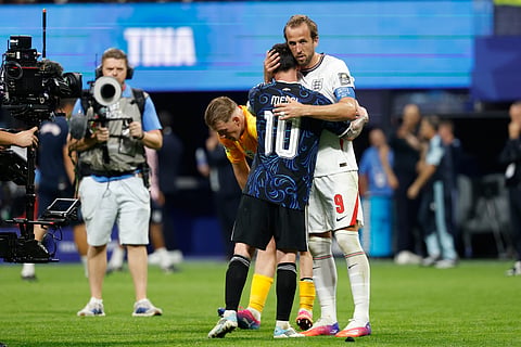 Argentina's Lionel Messi (10) and England's Harry Kane (9) hug after the World Cup semifinal soccer match