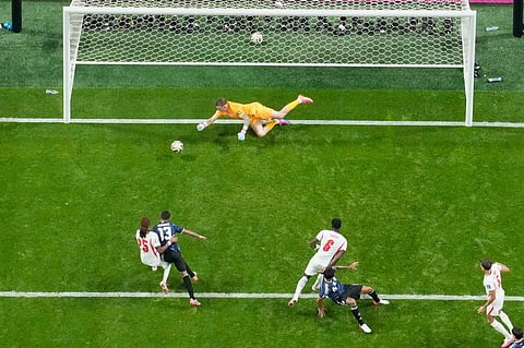 England goalkeeper Jordan Pickford (1) makes a save on a header by Argentina's Nico Gonzalez (15) during the World Cup semifinal soccer match 