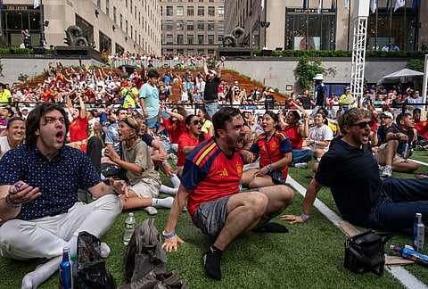 Spain fans react after the team scored their second goal during the World Cup quarterfinal soccer match between Spain and Belgium at a watch party at the Rockefeller Center fan village, Friday, July 10, 2026, in New York. 