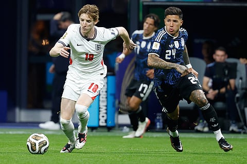 England's Anthony Gordon (18) and Argentina's Enzo Fernandez (24) run for the ball during the World Cup semifinal